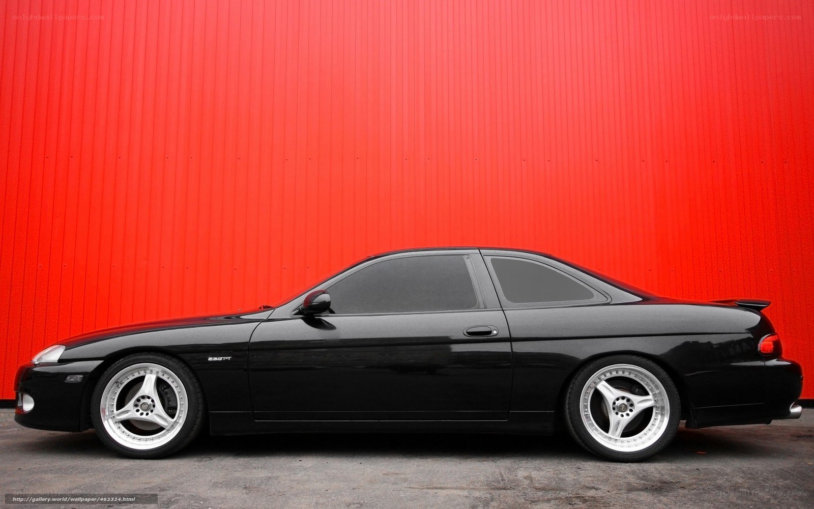 black coupe on red wall