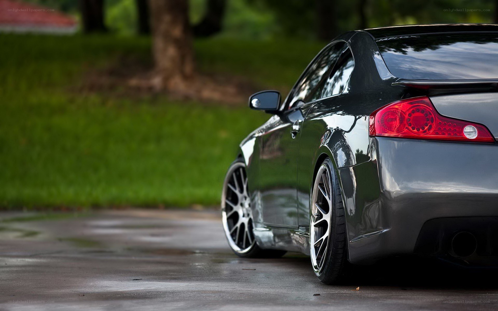 black coupe on wet pavement
