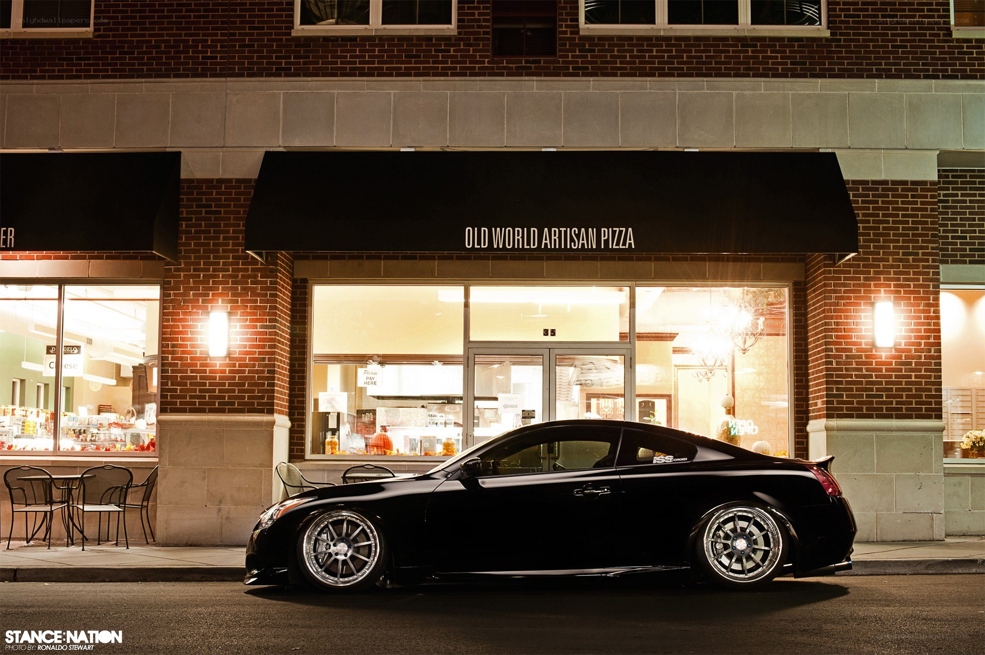 Black coupe outside pizza shop