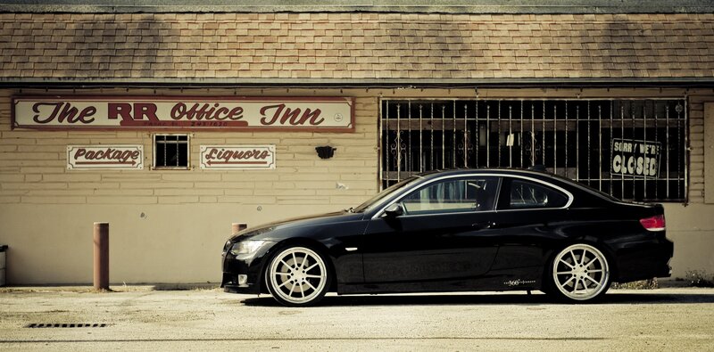 Black coupe parked in front of inn