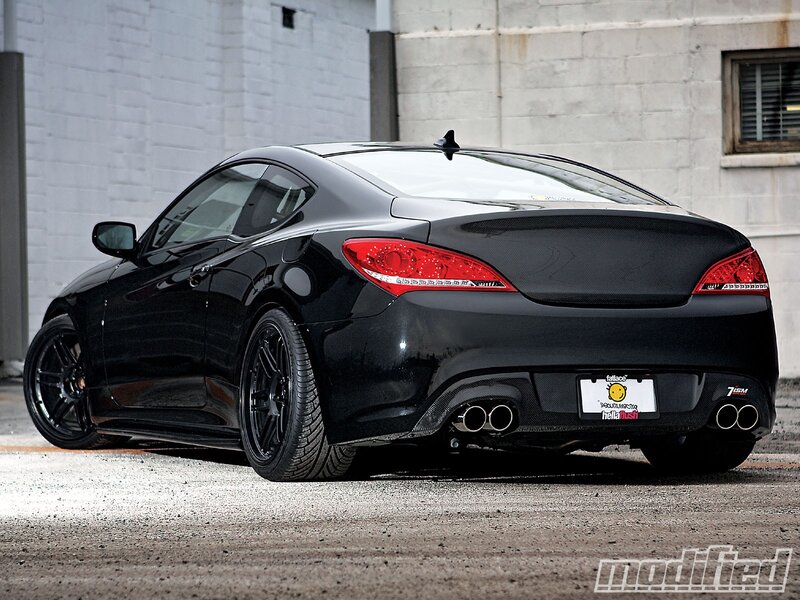 black coupe with carbon fiber accents