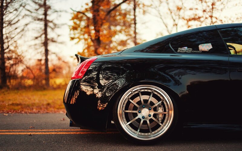 black coupe with custom wheels
