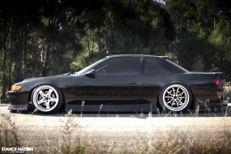 black coupe with custom wheels