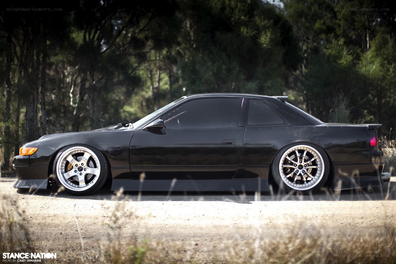 black coupe with custom wheels