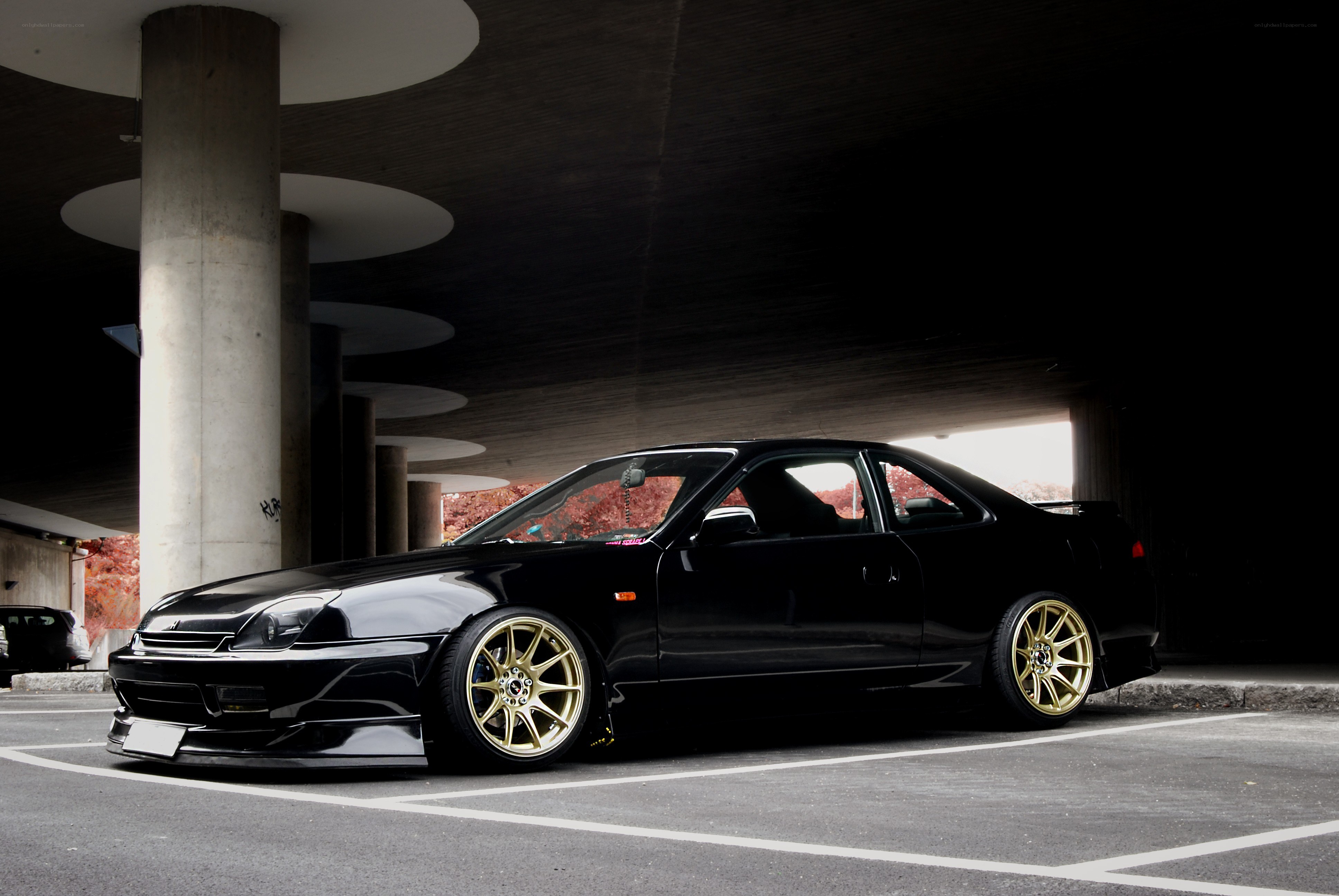 black coupe with gold wheels