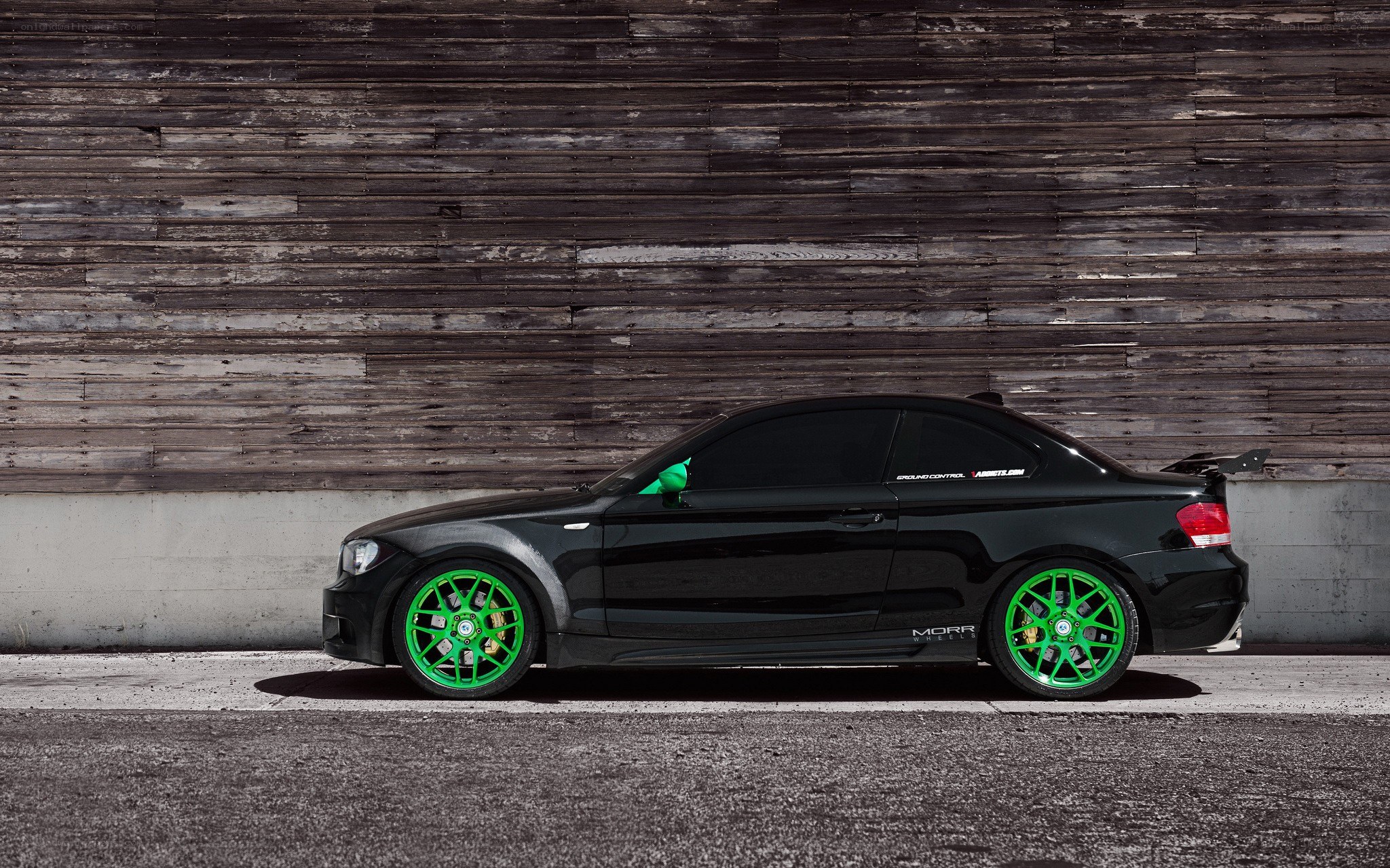 black coupe with green wheels
