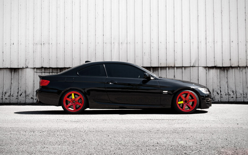 black coupe with red wheels