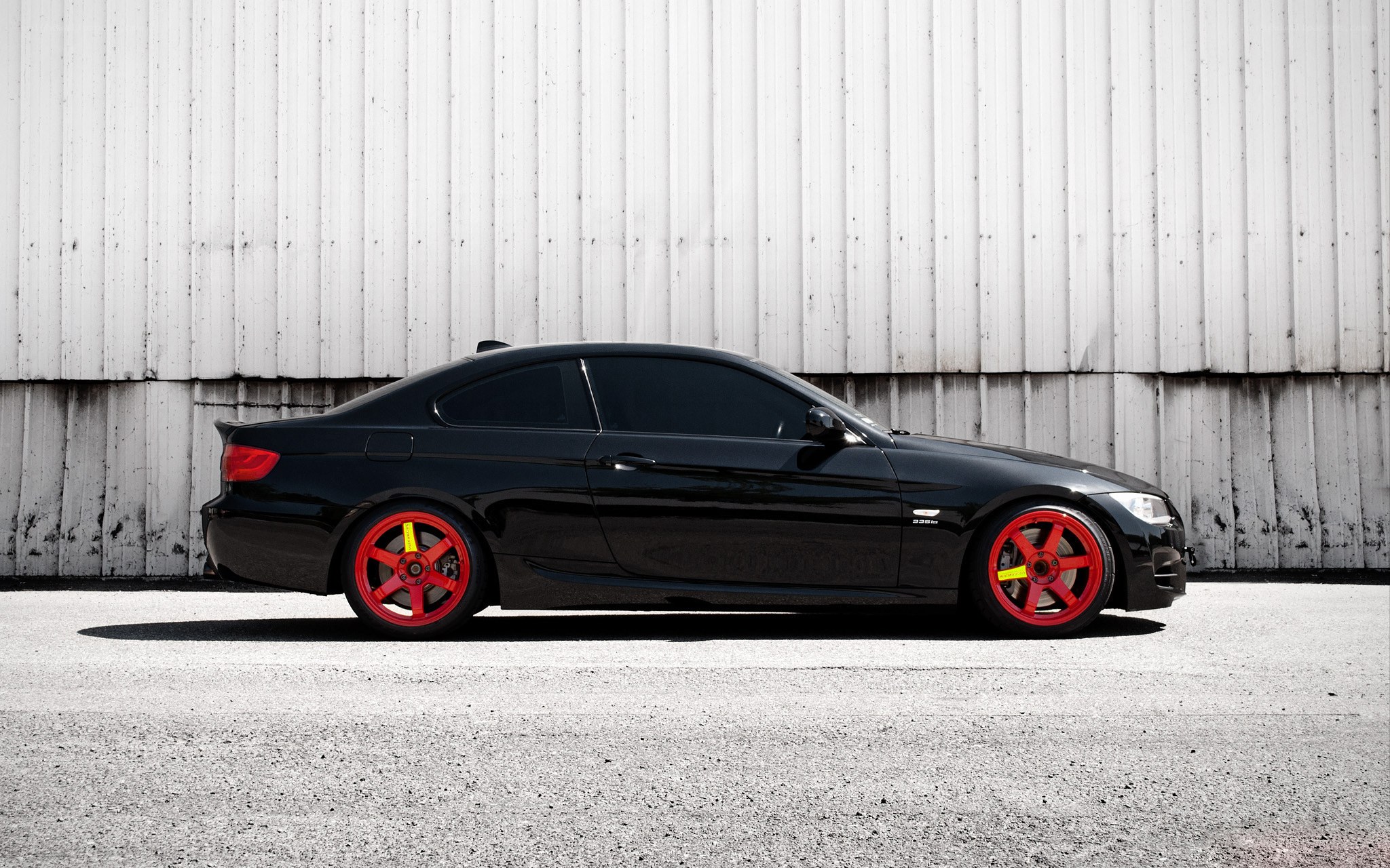 black coupe with red wheels