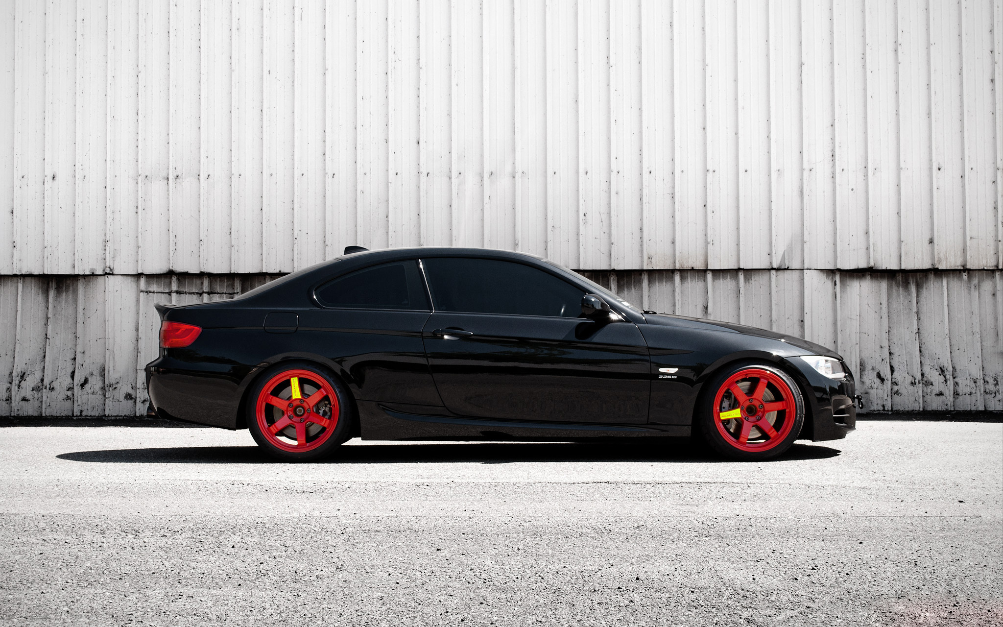 black coupe with red wheels