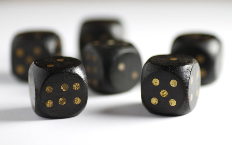black dice with gold dots