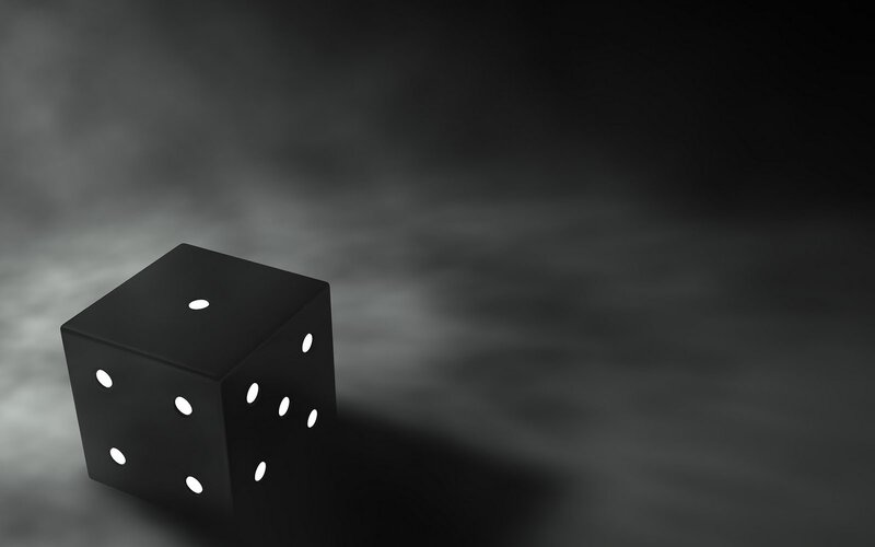 Black Die on Dark Surface