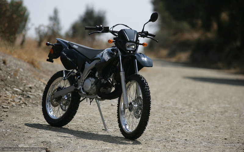 black dirt bike on gravel road
