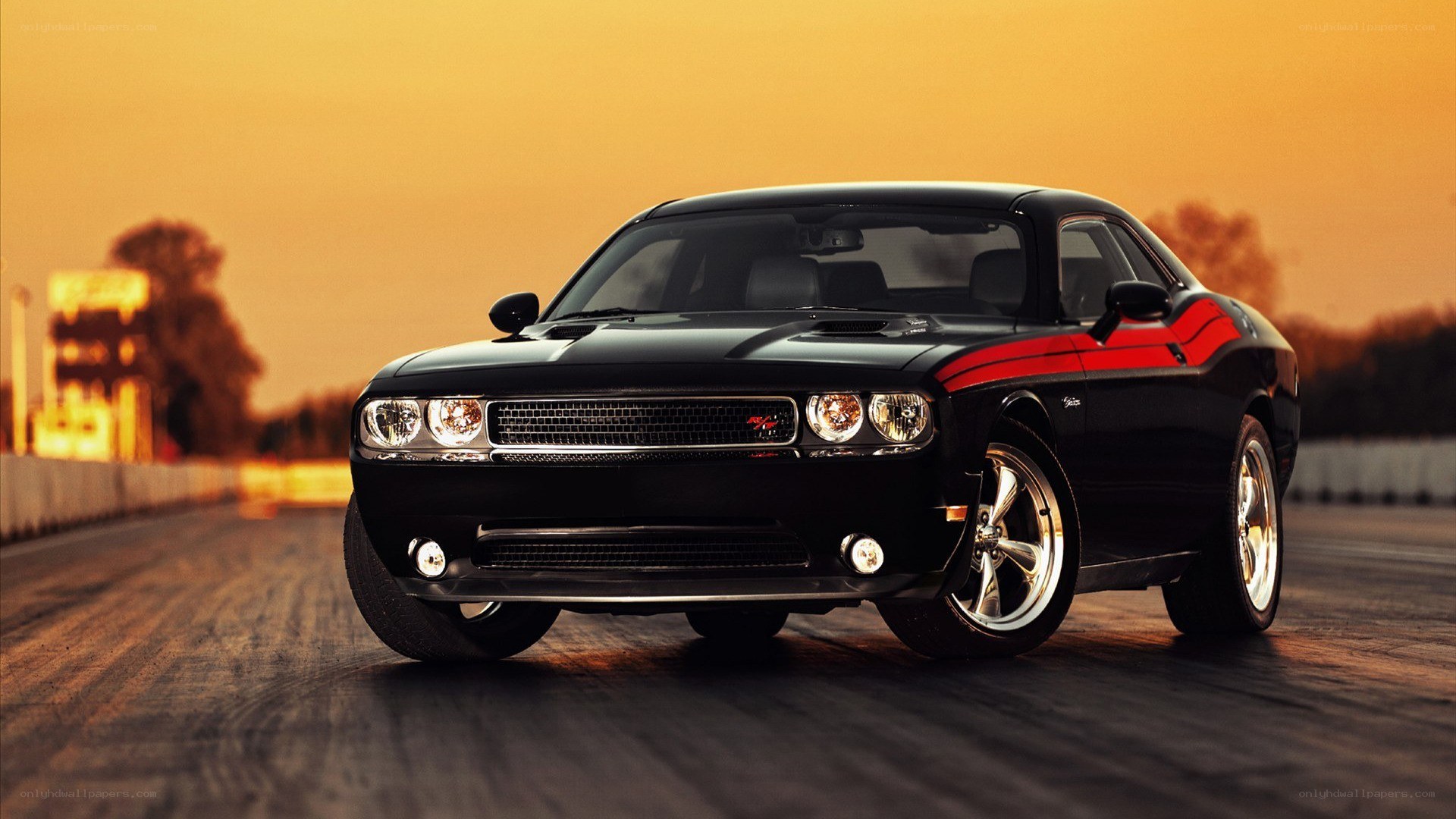 Black Dodge Challenger at sunset