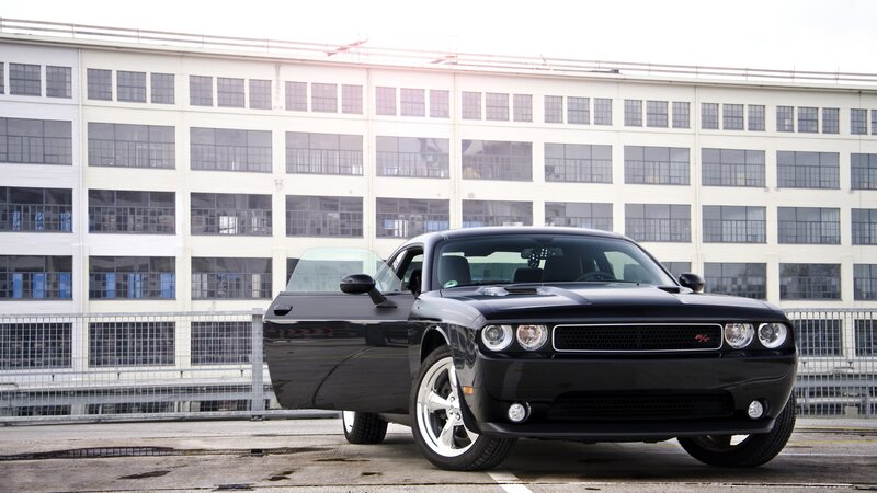 Black Dodge Challenger in front of building