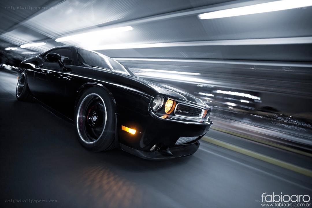 Black Dodge Challenger in motion