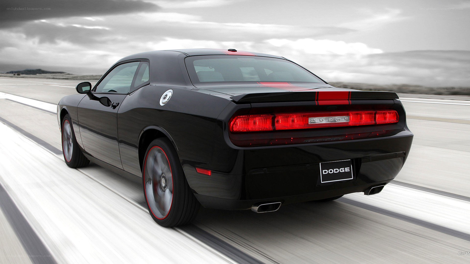 black dodge challenger in motion