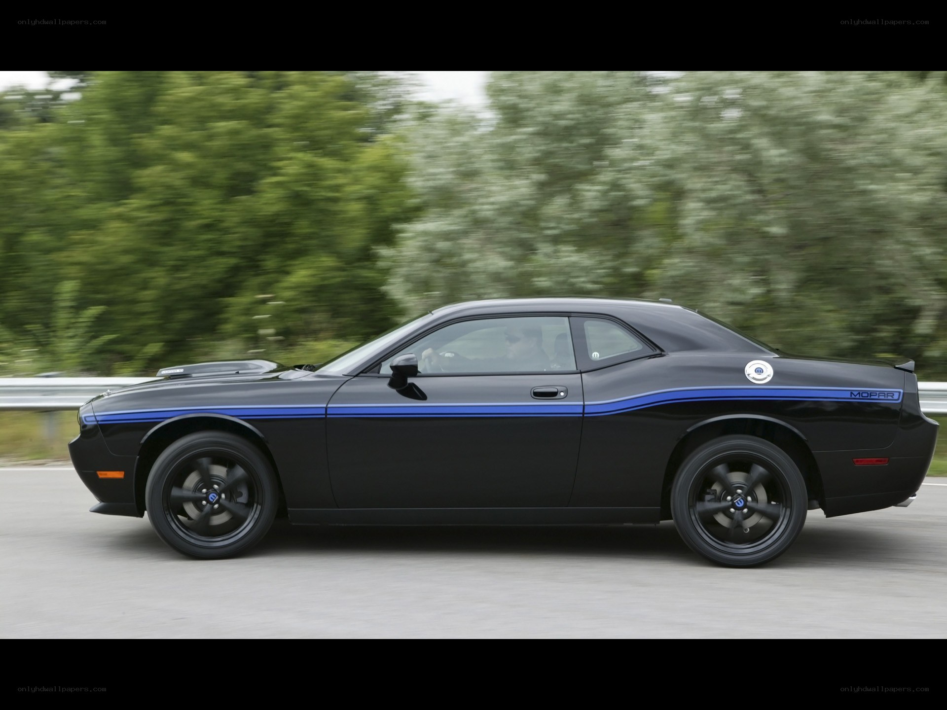 black dodge challenger in motion