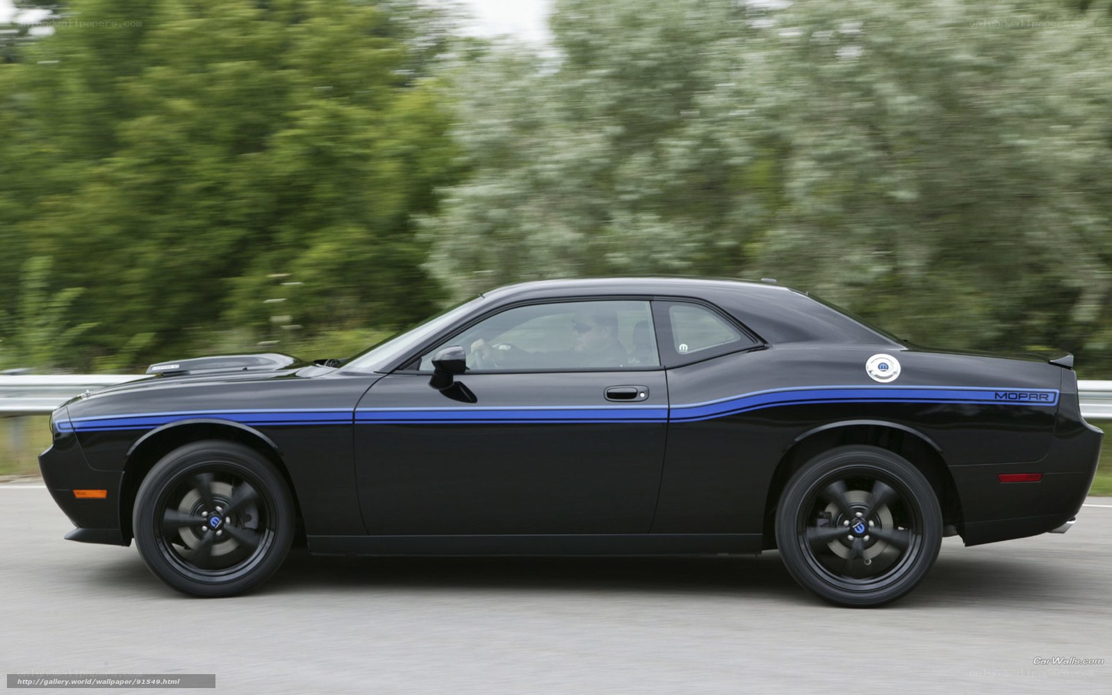 black dodge challenger in motion