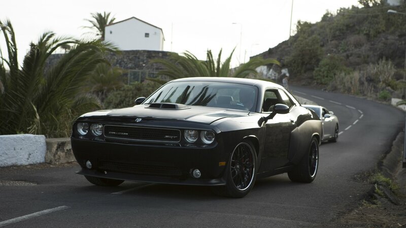 Black Dodge Challenger on a winding road