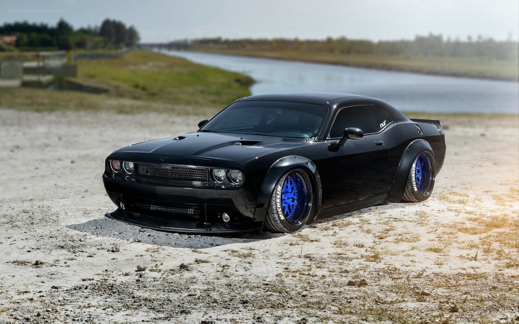 Black Dodge Challenger on beach