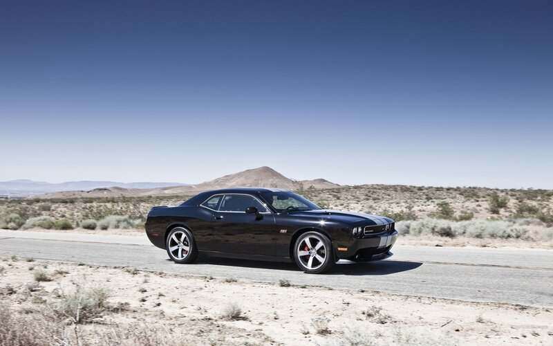 Black Dodge Challenger on desert road