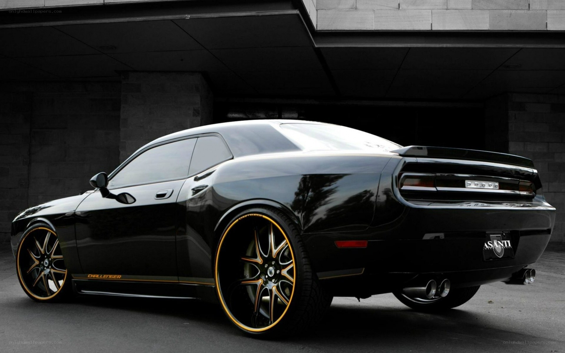 Black Dodge Challenger with gold rims