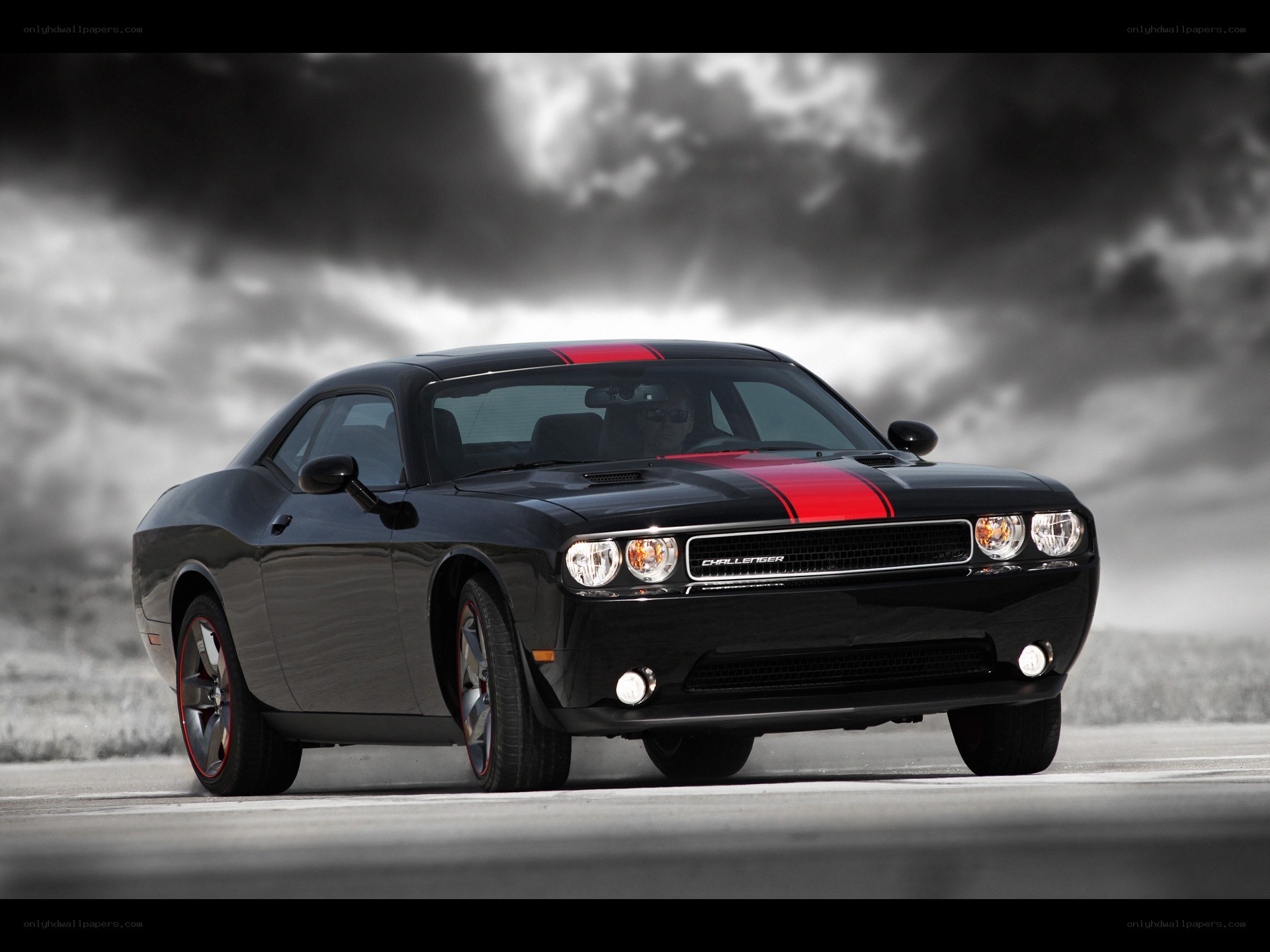 Black Dodge Challenger with red stripes