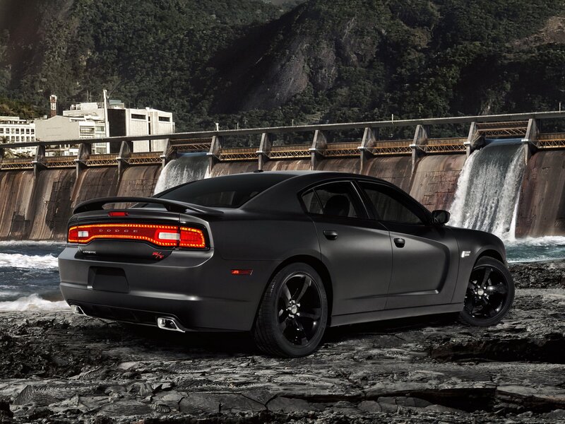 Black Dodge Charger by a dam
