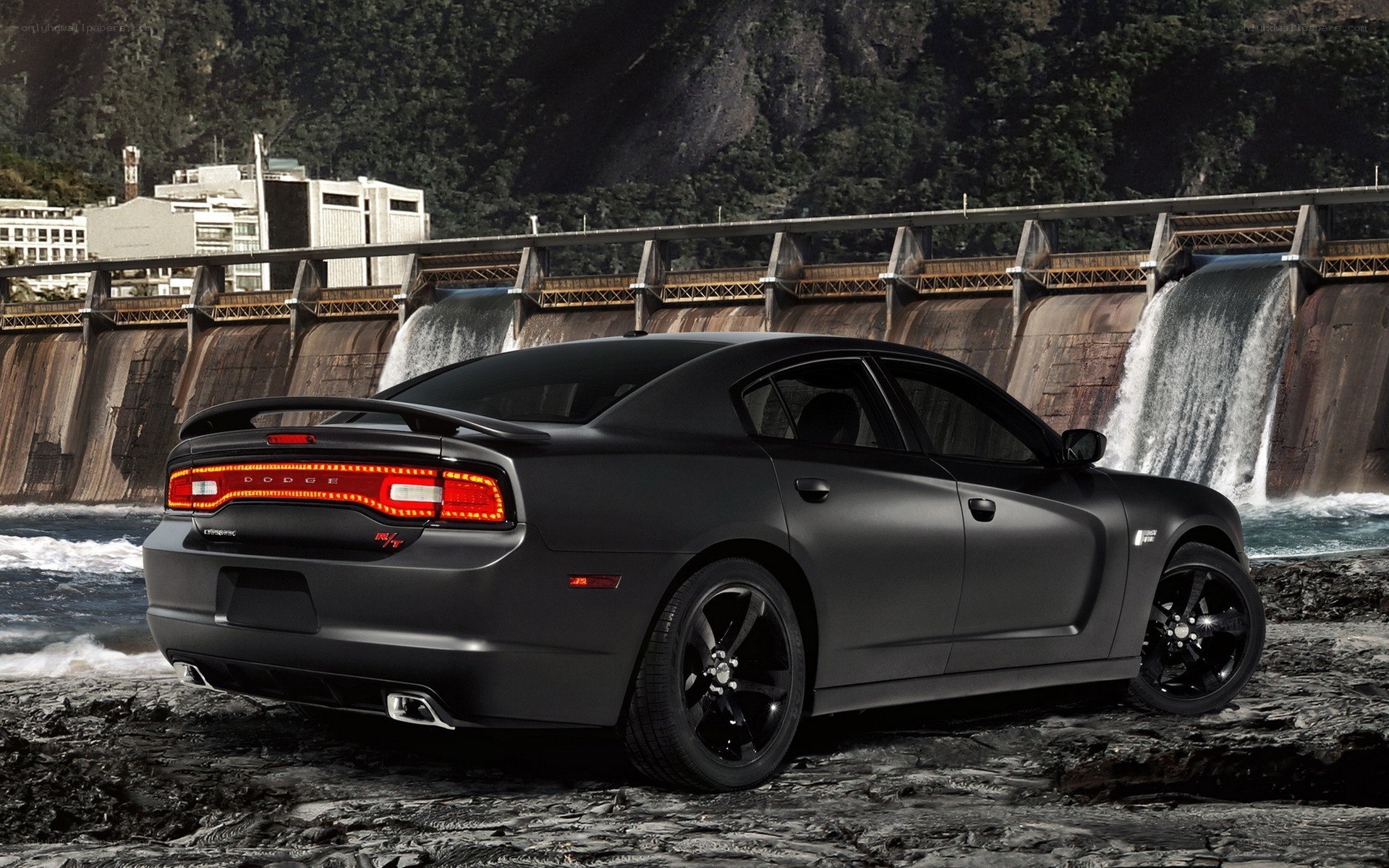 Black Dodge Charger by a dam