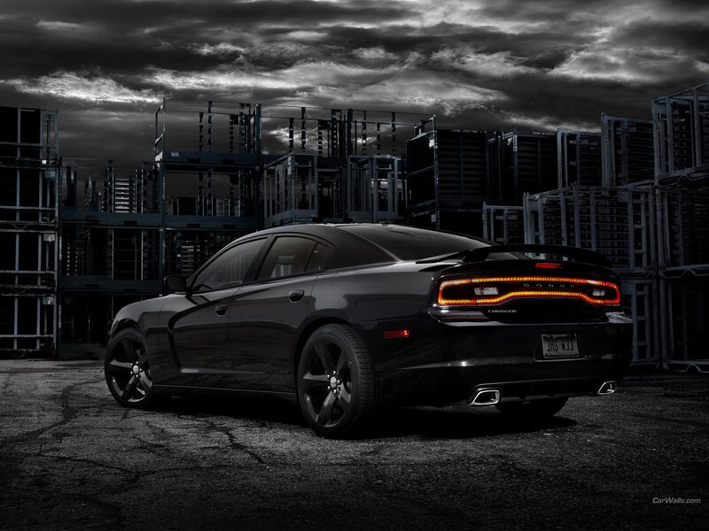 Black Dodge Charger in industrial setting