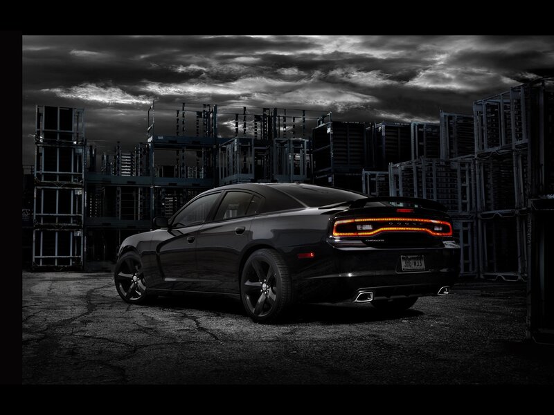 Black Dodge Charger in industrial setting
