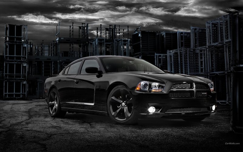 Black Dodge Charger in industrial setting