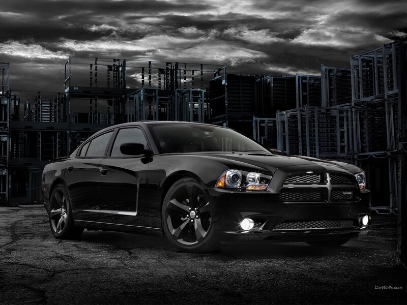 Black Dodge Charger in industrial setting