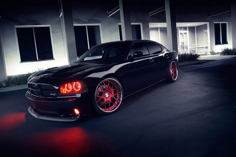 black dodge charger with red wheels