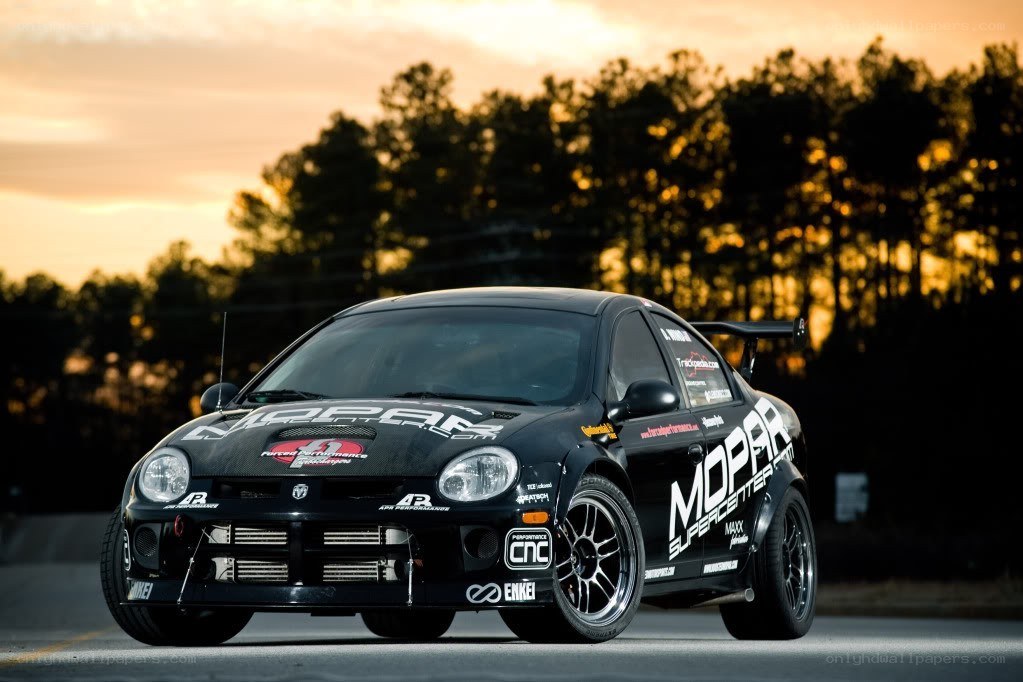 black dodge race car at sunset