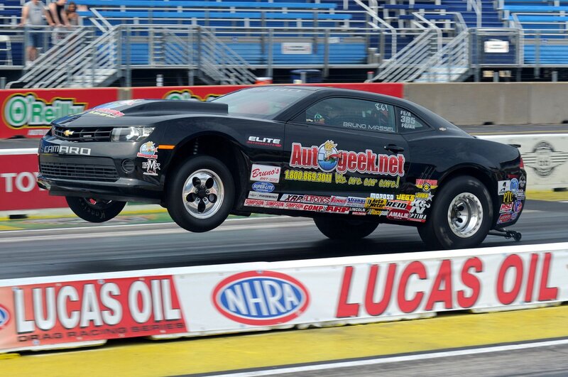 Black Drag Racing Car — Dynamic, Afternoon, Photograph, Race Track, Spectators, Banners