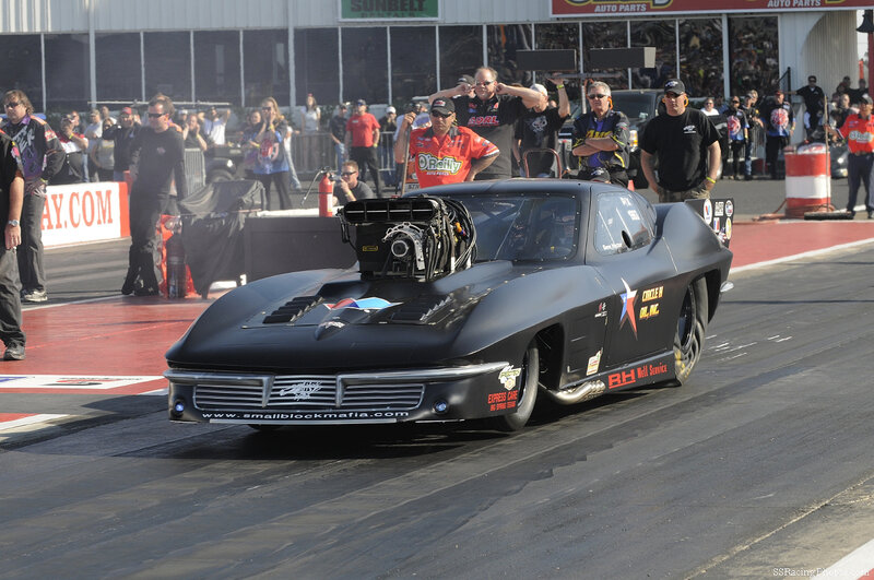 Black drag racing car on track