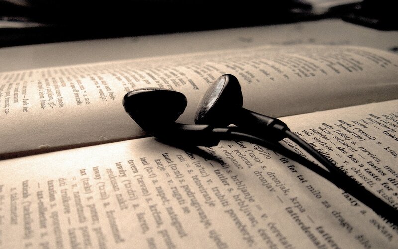 Black Earbuds on Book