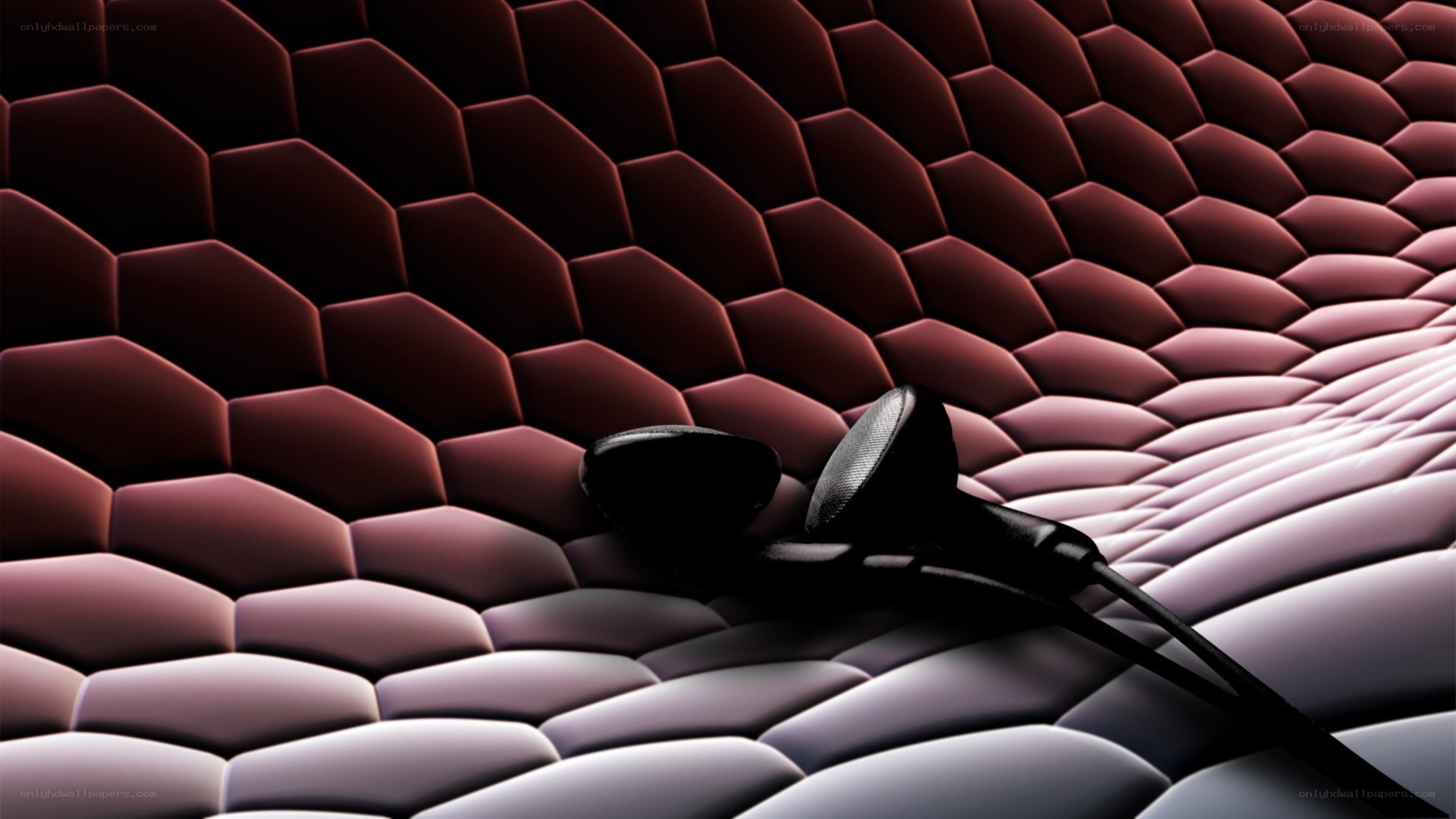 black earbuds on textured surface