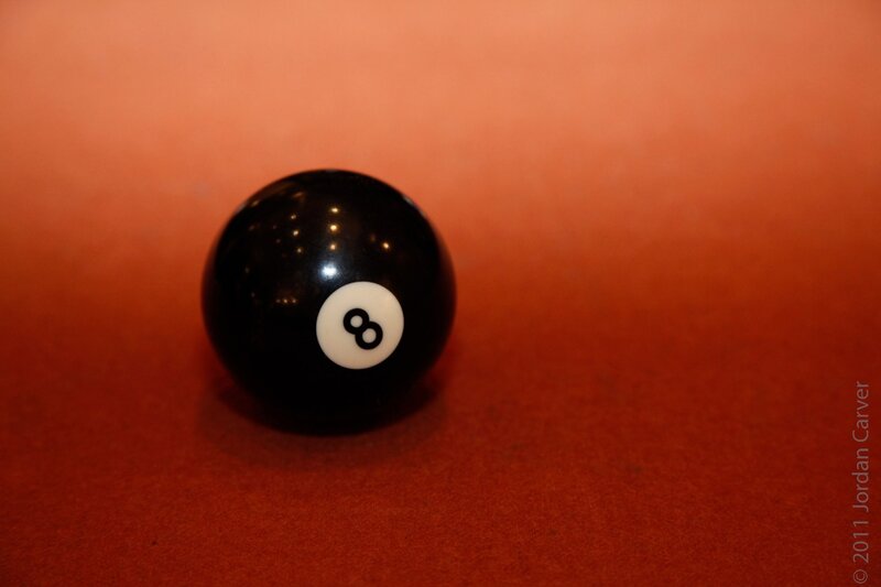 Black eight ball on red