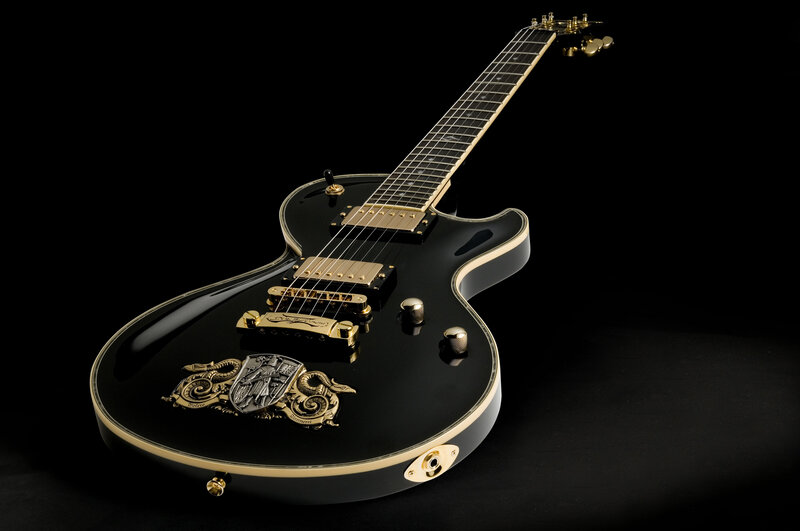 Black Electric Guitar — Dramatic, Photograph, Gold Hardware, Crest Emblem