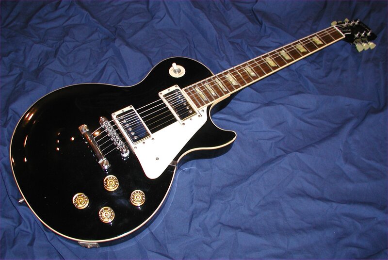 Black Electric Guitar — Neutral, Photograph, Blue Fabric