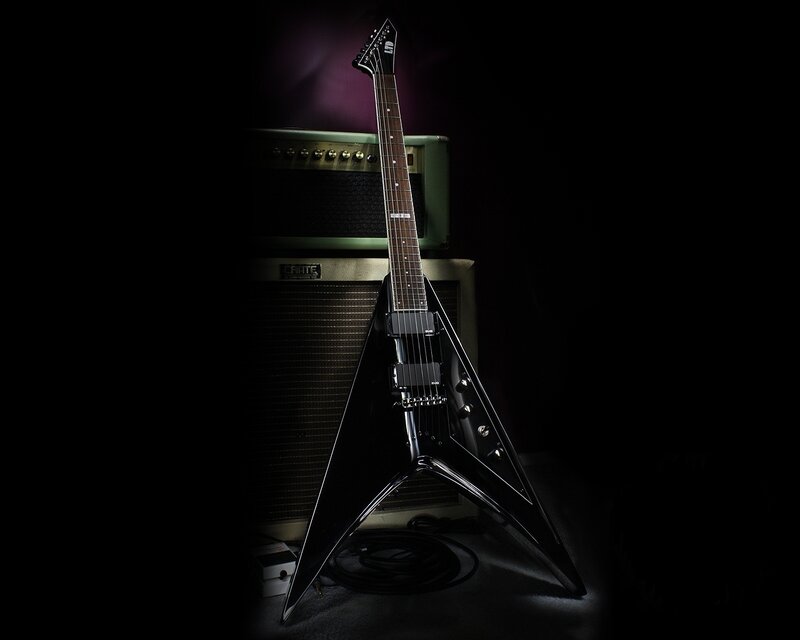 black electric guitar on amplifier
