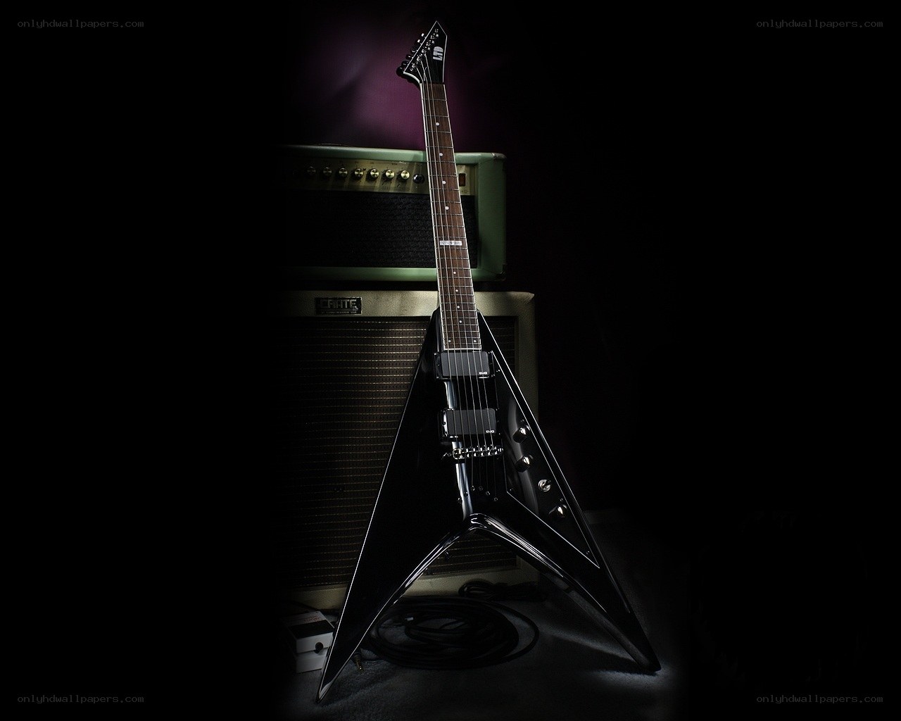 black electric guitar on amplifier