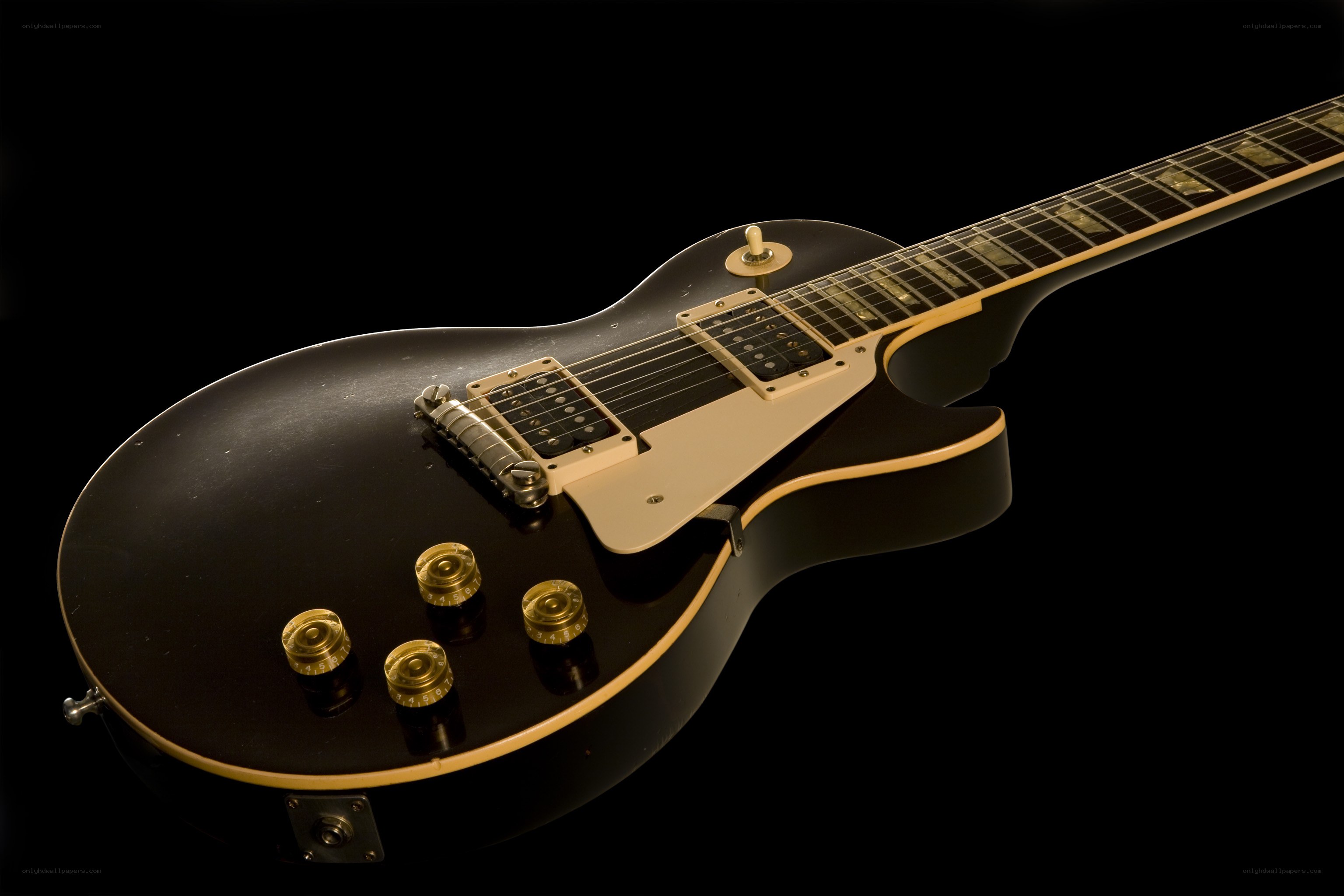 black electric guitar on black