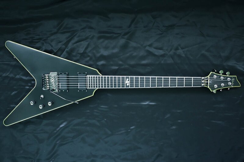 black electric guitar on black background