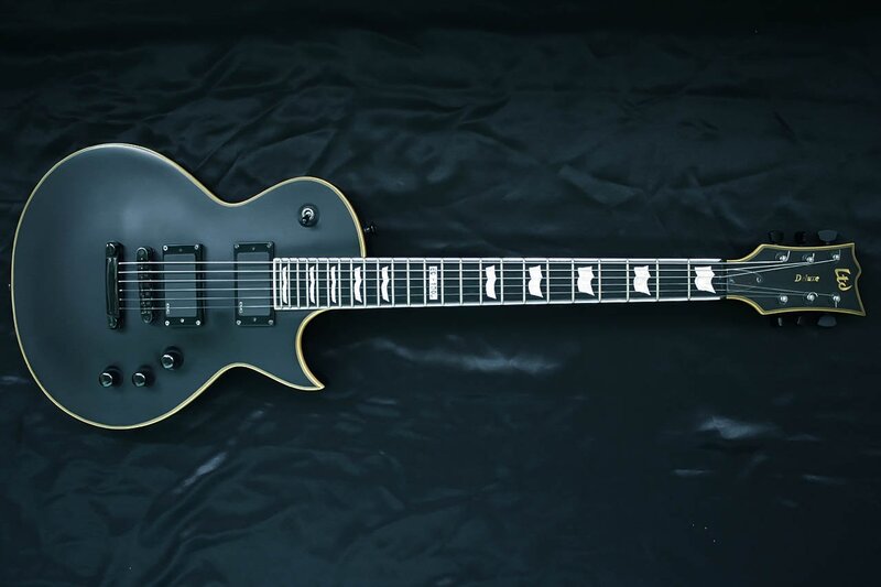 black electric guitar on black cloth