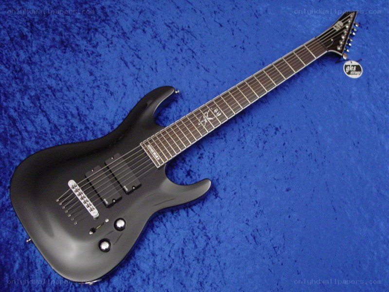 black electric guitar on blue