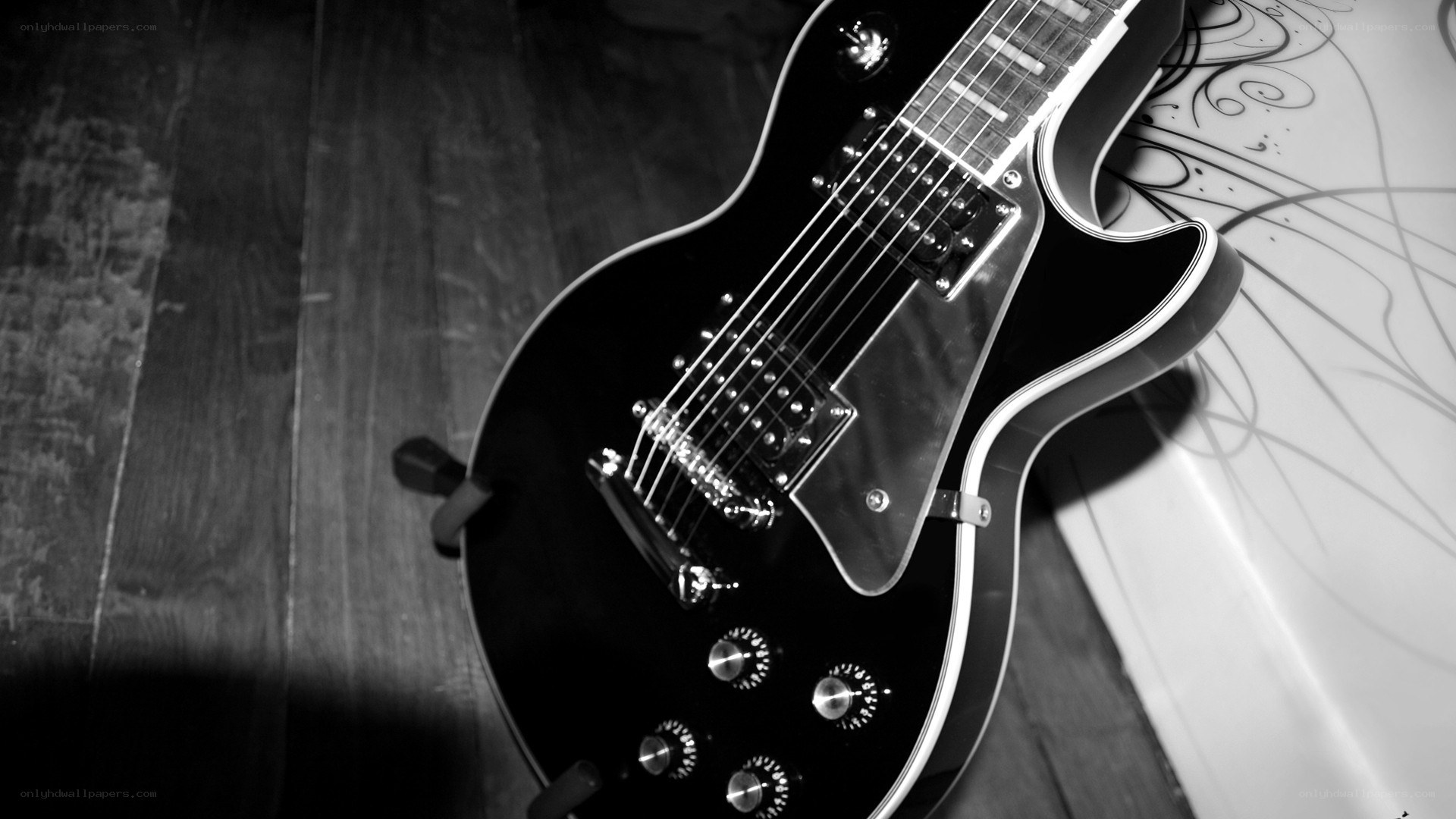 black electric guitar on floor