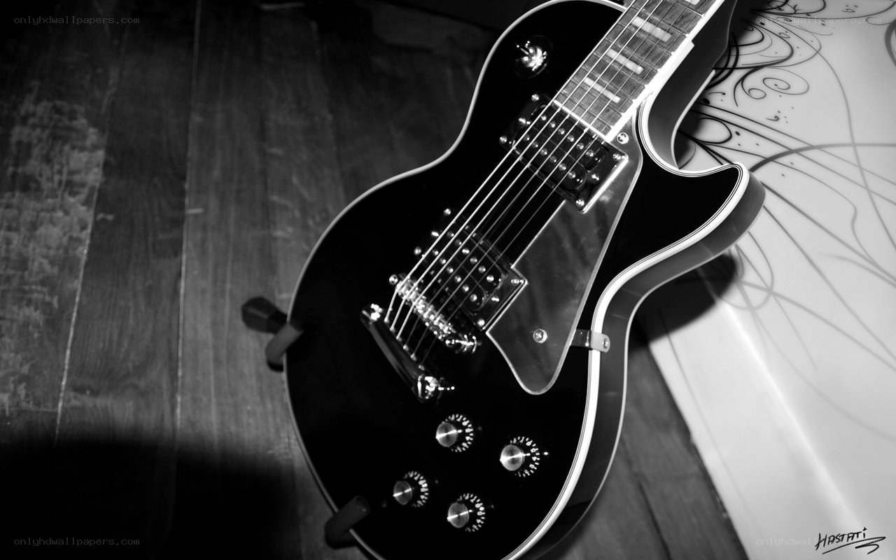 black electric guitar on floor